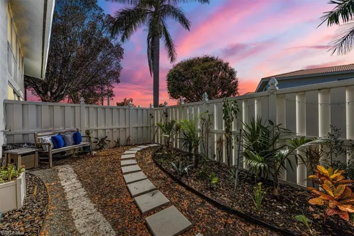 View of fenced yard at dusk