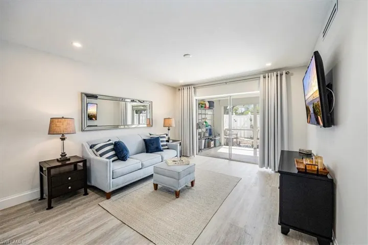 Living room with sliding doors (which pocket) to the large screened, covered patio