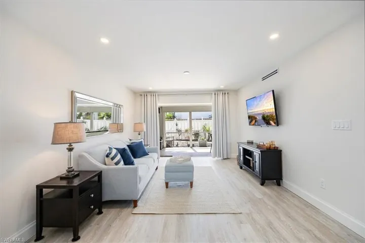 Living room with sliding doors (which pocket) to the large screened, covered patio