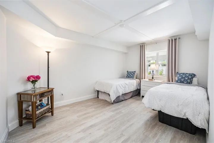 Large guest bedroom overlooks the screened patio and private courtyard