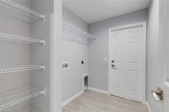 Laundry room with light wood finished floors, washer hookup, and electric dryer hookup
