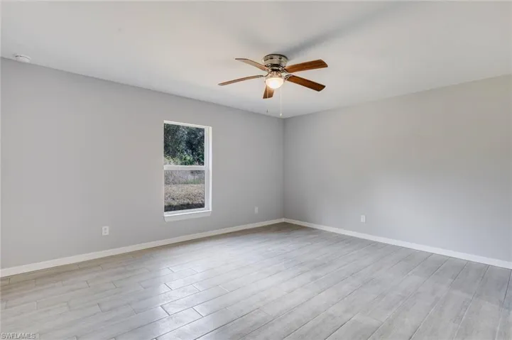 Spare room with light wood-type flooring and a ceiling fan