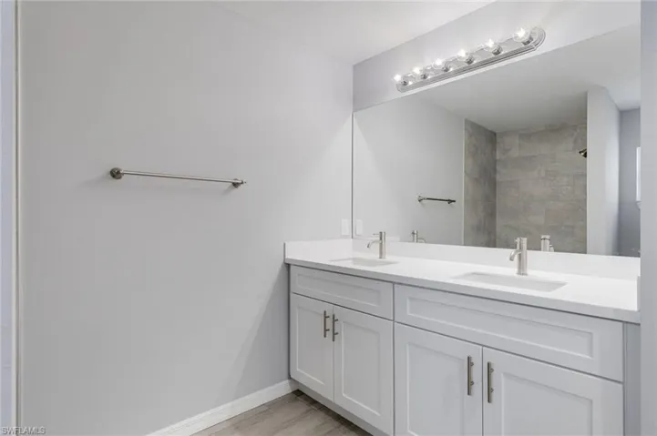Bathroom with double vanity and a shower