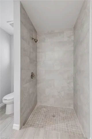 Full bath with a shower stall and toilet