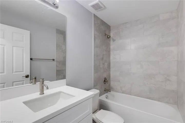 Bathroom with vanity and shower / washtub combination
