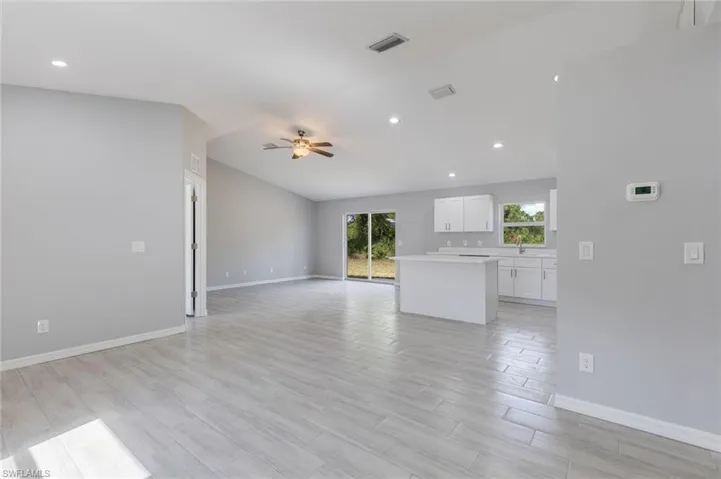 Unfurnished living room with wood finish floors, recessed lighting, and ceiling fan