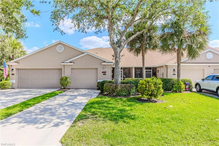 Single story home with stucco siding, driveway, a front lawn, and a garage