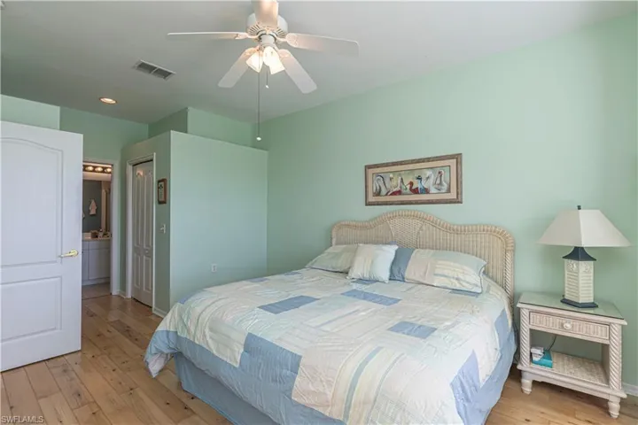 Bedroom featuring a closet, light wood-style floors, a ceiling fan, and recessed lighting
