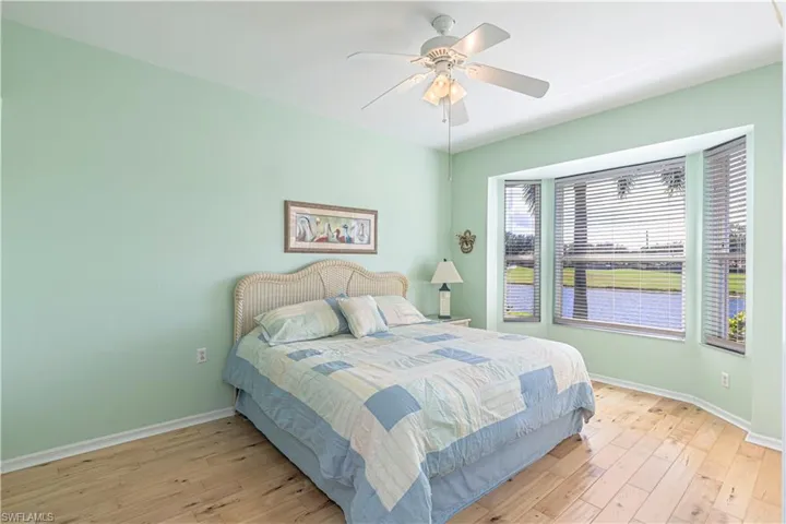 Master Bedroom with light wood-style flooring and ceiling fan