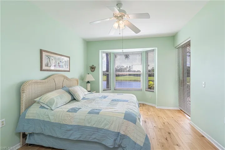 Master Bedroom with multiple windows, hardwood / wood-style flooring, and a ceiling fan