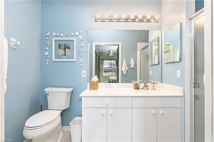 Master Full bathroom with a shower stall, vanity, and light tile patterned floors