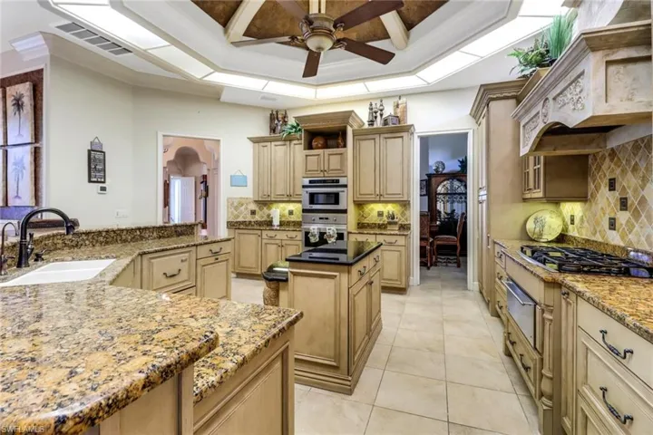 Extensive chef's kitchen with gas stovetop, a kitchen island, double sink and two dishwashers.