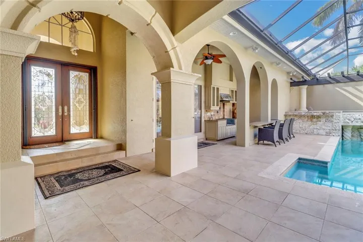 Entrance to courtyard home.  Lanai features a patio area and partial outdoor kitchen with wet bar. Spa is to the right rear.