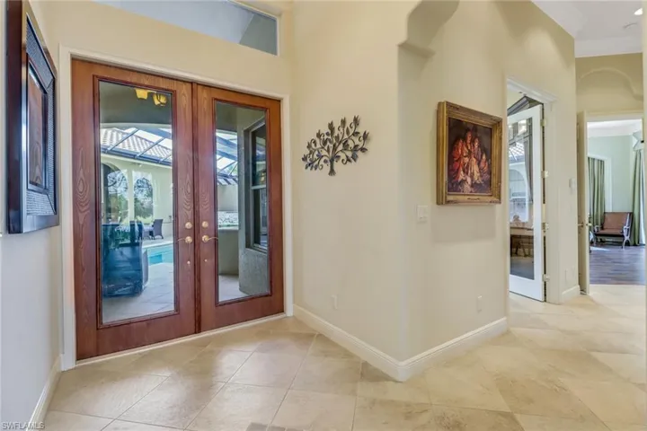 Foyer featuring double french doors. Entry to office and master bedroom to the right