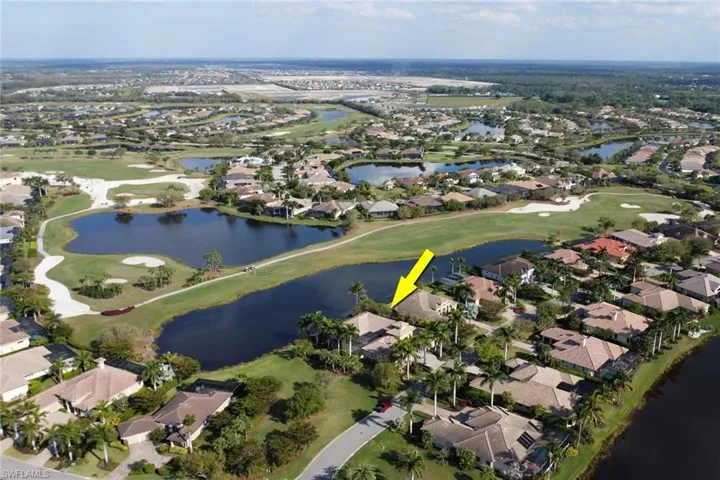 Aerial view with view of golf course, a water view, and a residential view