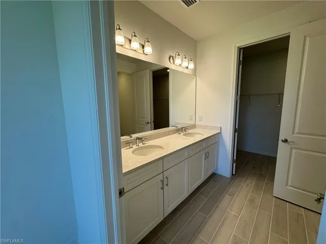 Primary bathroom with quartz countertops, dual-sinks, and soft-close cabinetry