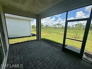 Underneath covered lanai with screen enclosure and granite pavers