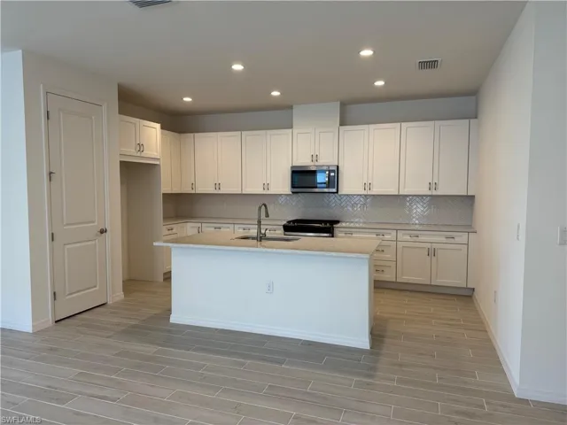 Beautiful kitchen layout with ample cabinetry, quartz countertops, and soft-close cabinets
