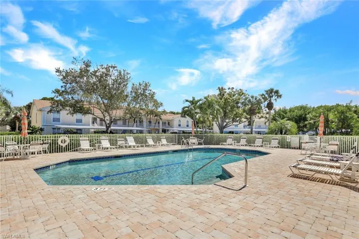 Community pool featuring a patio area and a residential view