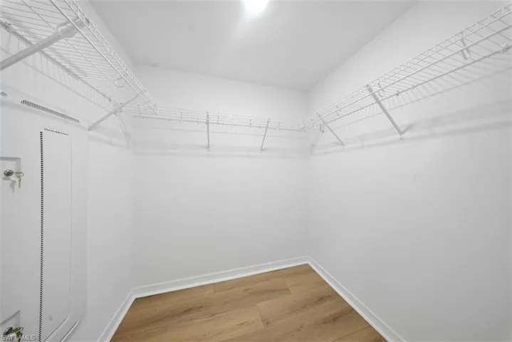 Walk in closet featuring light wood-style floors