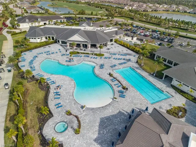 Community pool with a water view, a patio, and a residential view