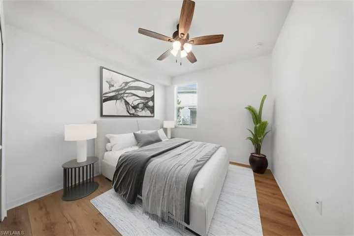 Bedroom featuring wood finished floors and a ceiling fan