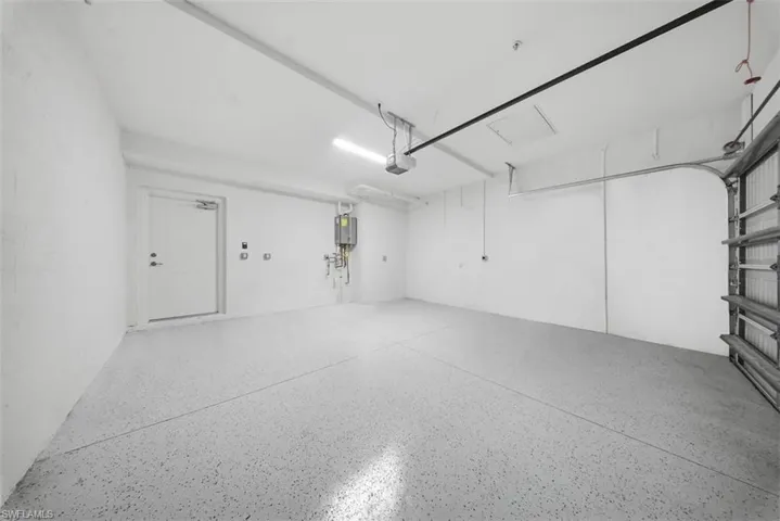 Garage featuring tankless water heater
