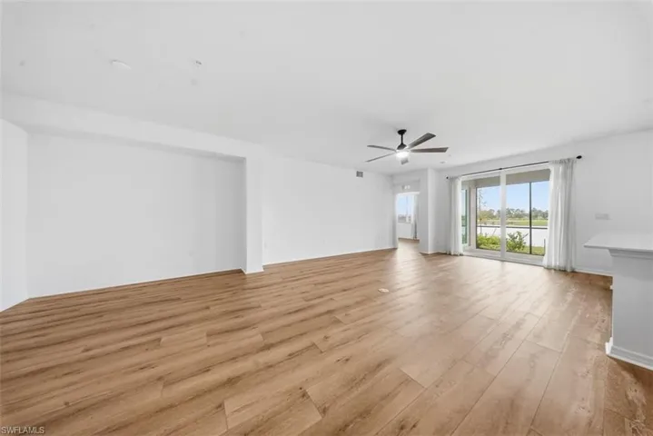 Unfurnished living room with light wood finished floors and a ceiling fan