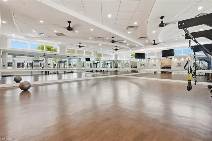 Workout area featuring ceiling fan and recessed lighting