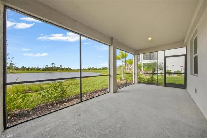 Unfurnished sunroom featuring a water view