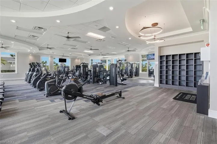 Exercise room with recessed lighting, ceiling fan, and a drop ceiling