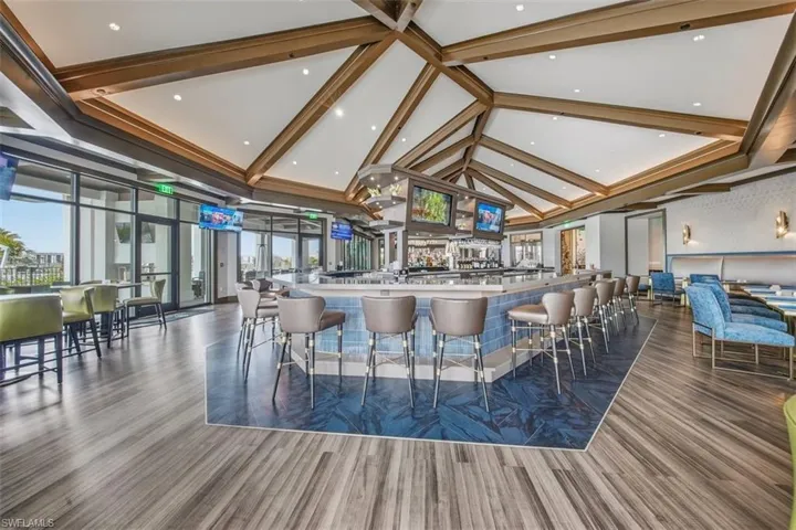 Bar area with high vaulted ceiling and beamed ceiling