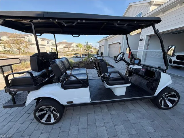 View of parking featuring a residential view and a garage