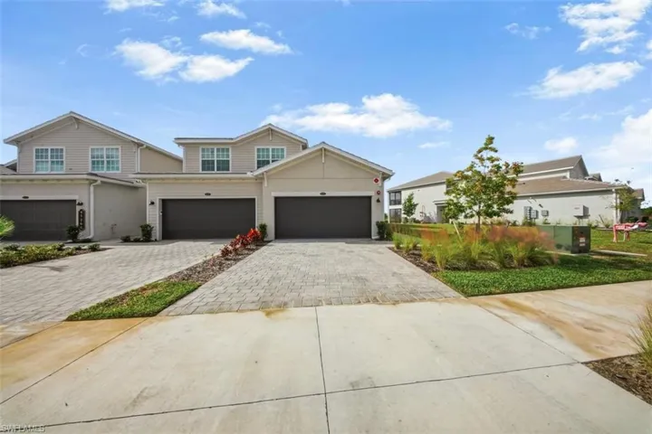 Traditional home featuring decorative driveway