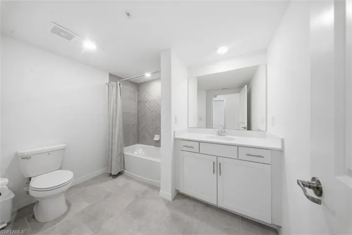 Full bathroom featuring vanity and shower / bath combination with curtain
