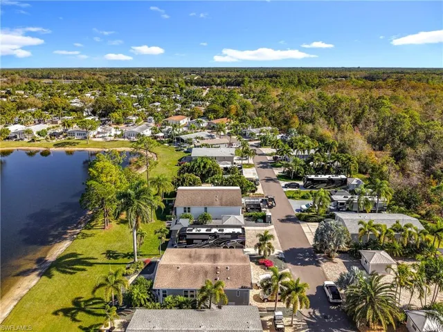 Aerial perspective of suburban area featuring a nearby body of water