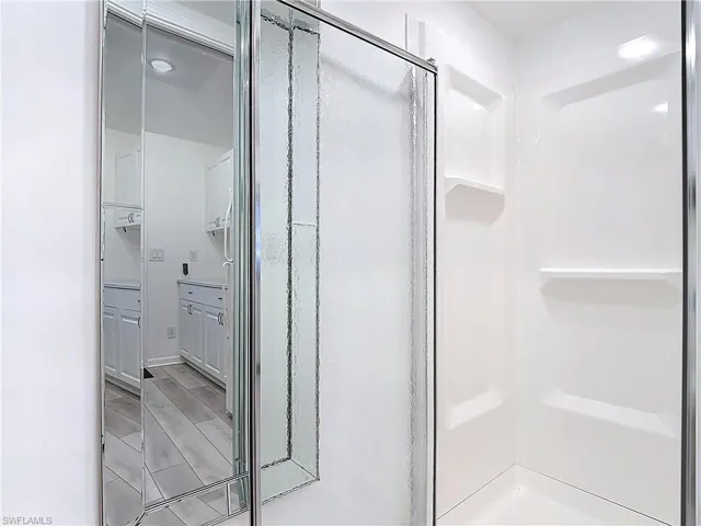 Bathroom featuring a stall shower and wood tiled floors