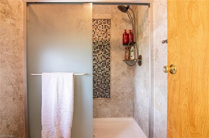 Full bathroom featuring a stall shower