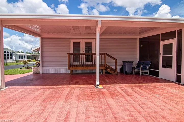View of patio with a sunroom