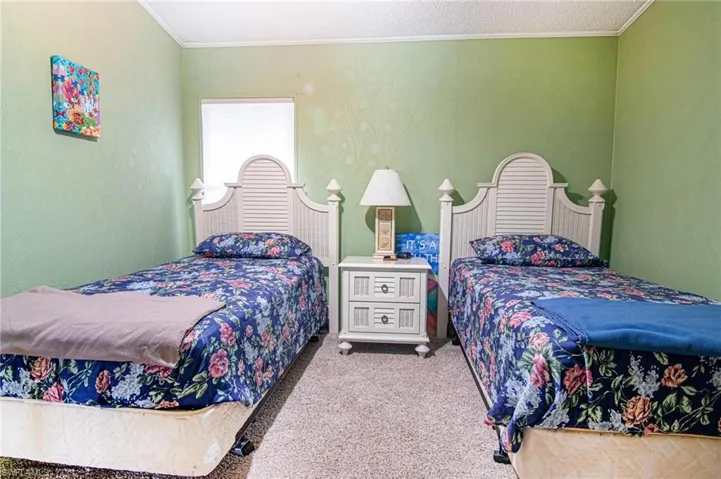 Bedroom featuring carpet flooring and ornamental molding