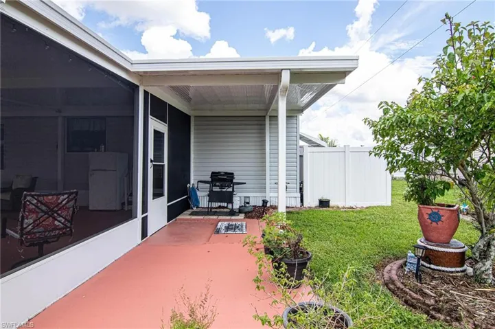 View of patio featuring a grill, a sunroom, and fence