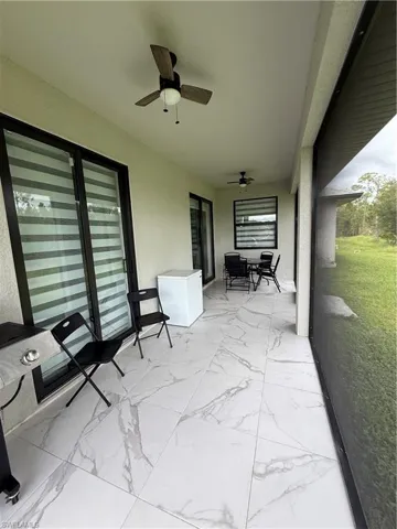 View of patio / terrace with a sunroom and ceiling fan