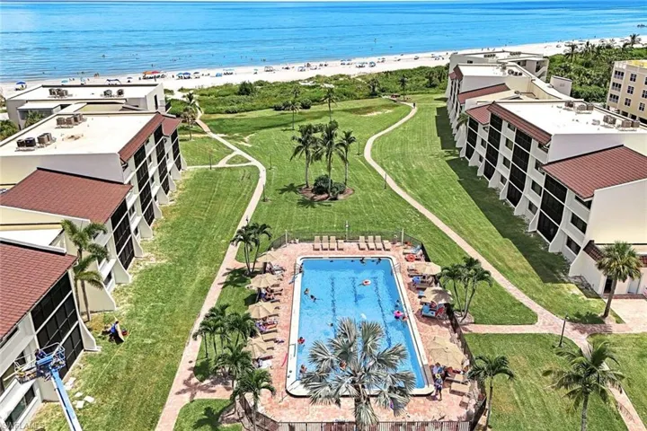 Aerial view featuring a beach view and a water view