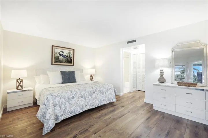 Bedroom with hardwood / wood-style floors and a closet
