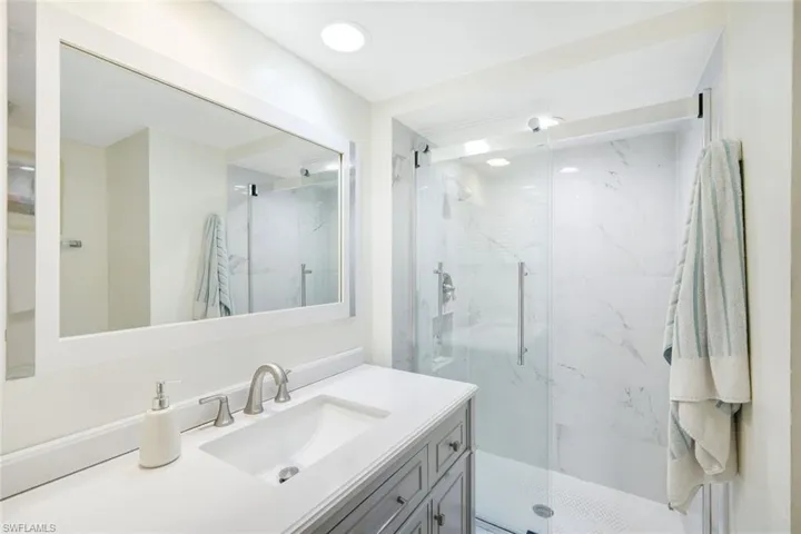 Bathroom with an enclosed shower and vanity