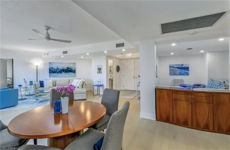Great room area with 8'4" ceilings looking into the den/office.  Engineered wide-plank wood floors.