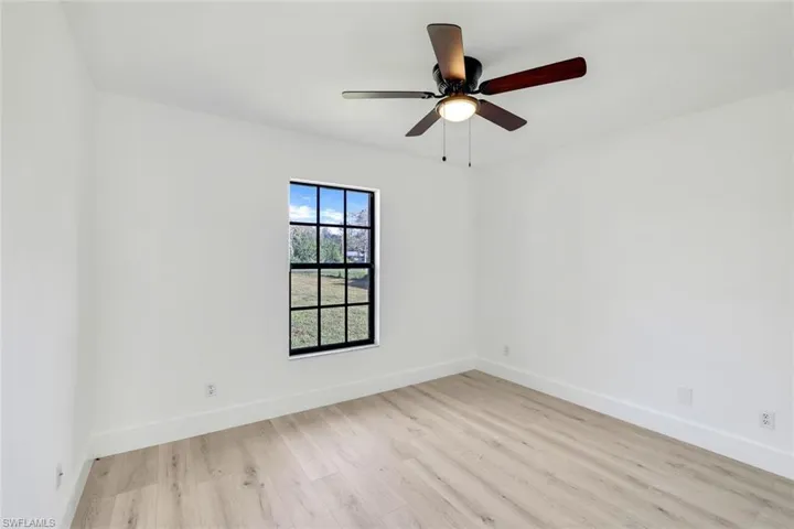 Spare room featuring ceiling fan and light hardwood / wood-style floors