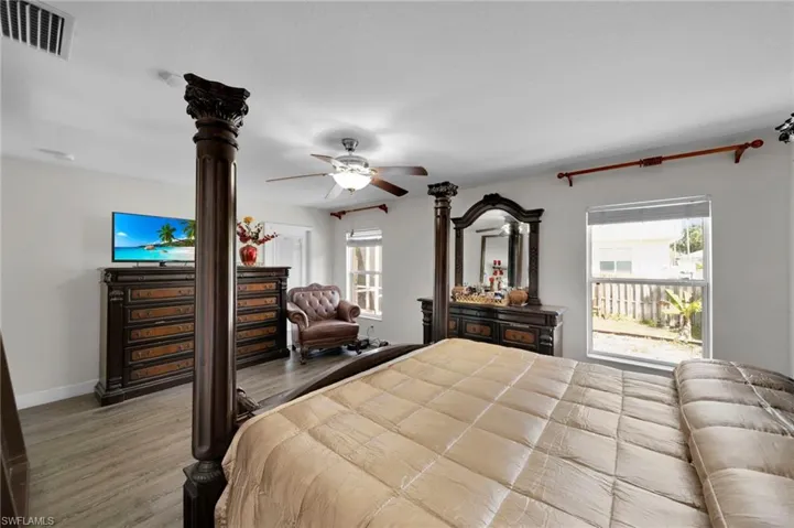 Bedroom with visible vents, baseboards, a ceiling fan, and wood finished floors