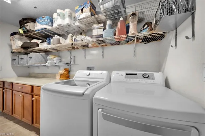 Laundry area featuring cabinet space and washer and dryer