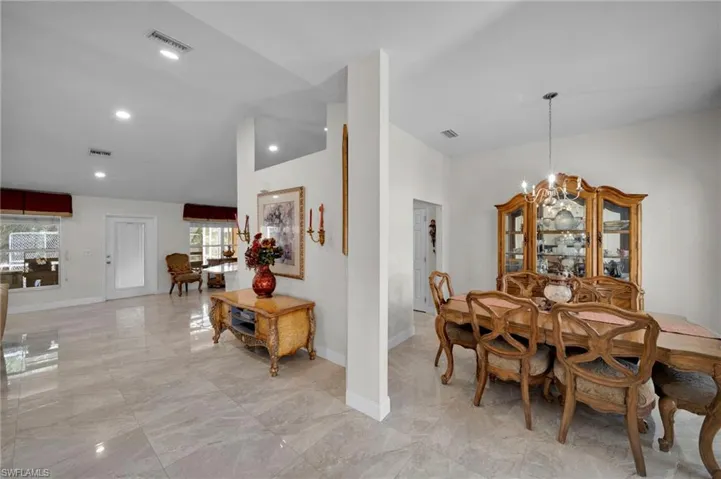 Dining room with marble finish floor, baseboards, and visible vents